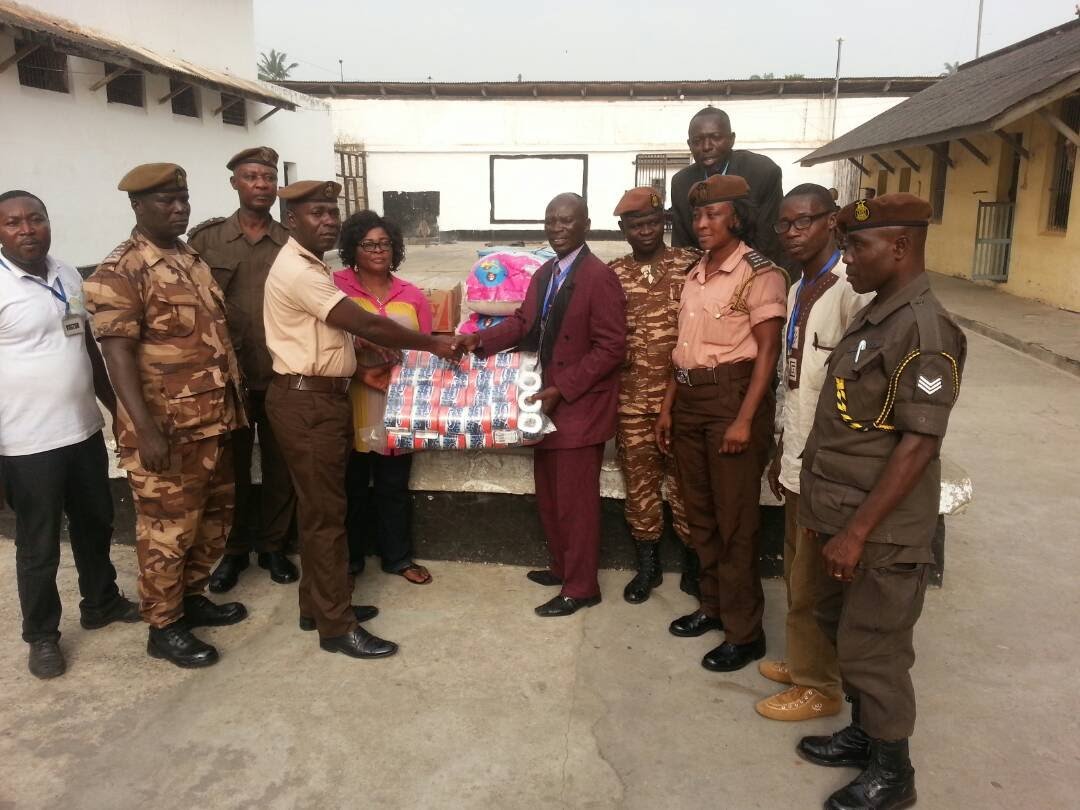 Presenting relief items to prison officers in the prison yard.